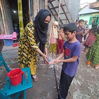 Abdullah washing hands in the handwashing day program