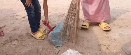 Salman and Isa cleaning the neighborhood