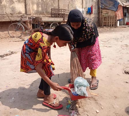 Sultana and Sadia cleaning the neighborhood